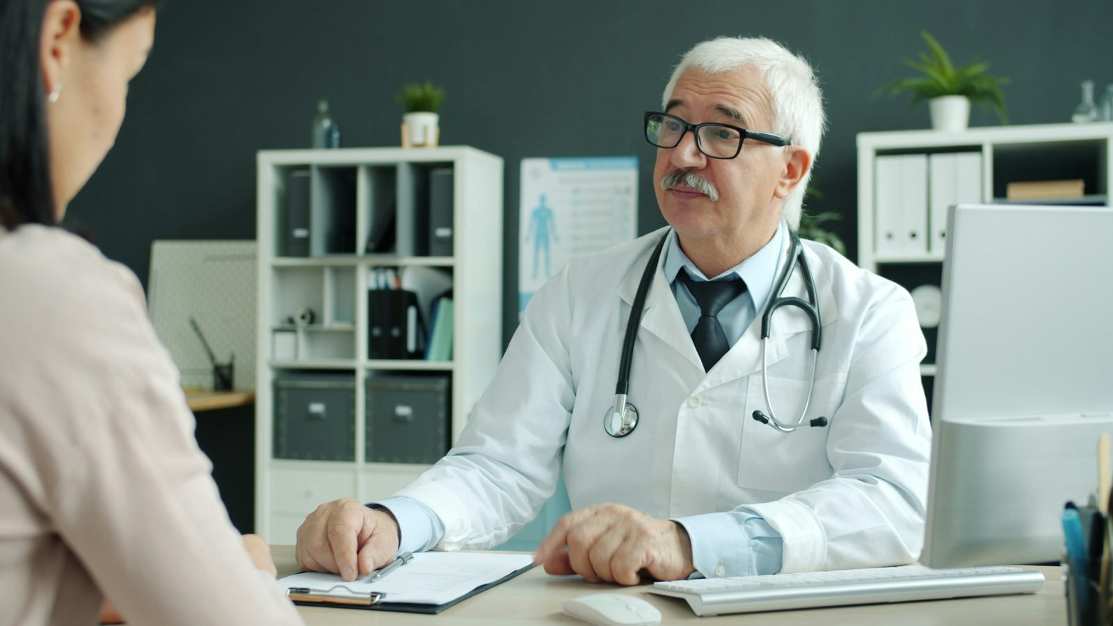 Doctor listening to a patient during an office visit